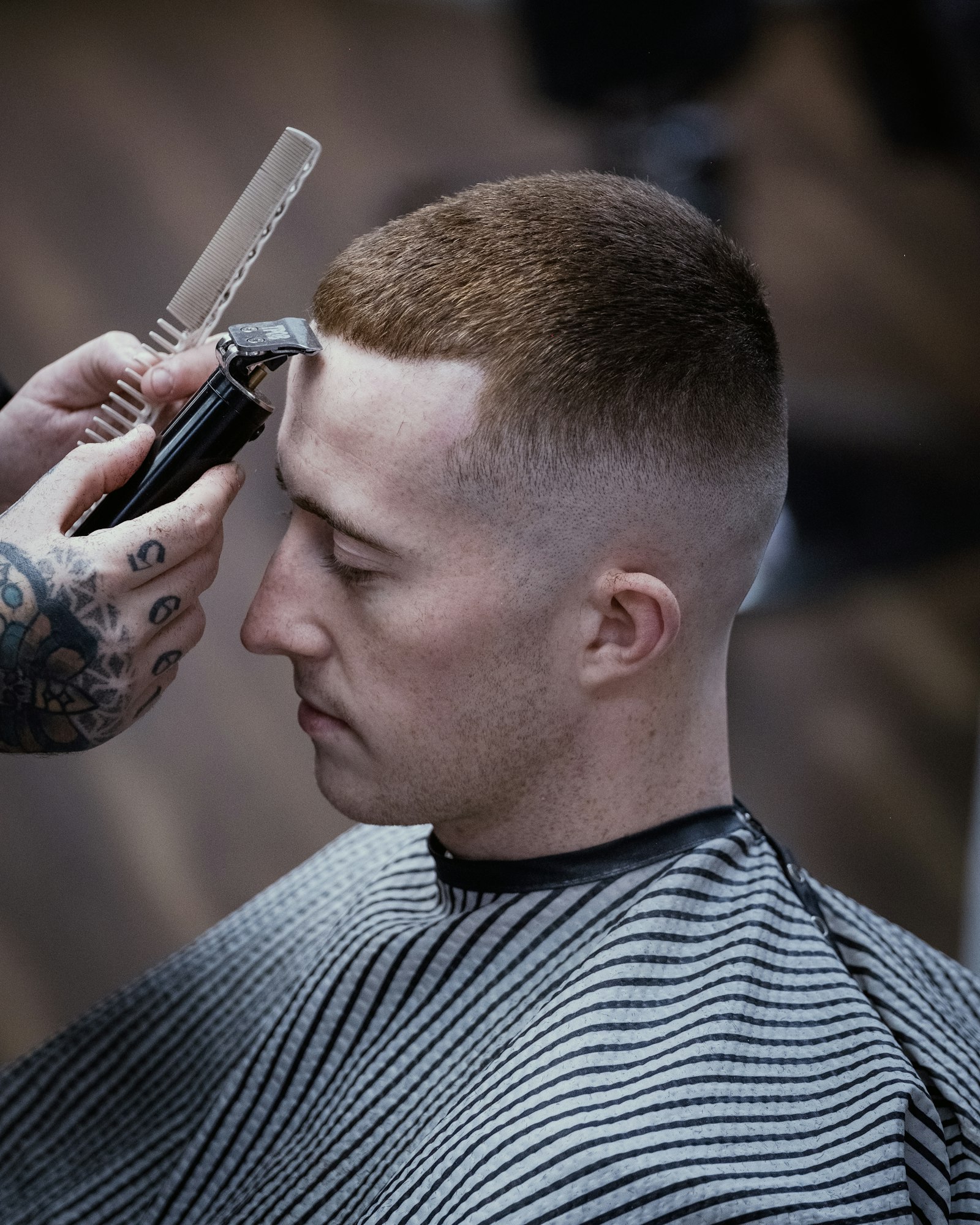 Barber refining the edges of a client's haircut with clippers